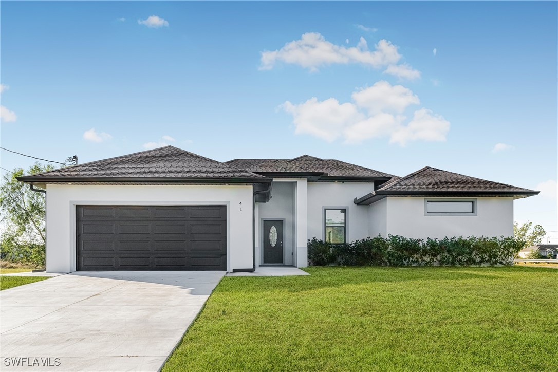 a front view of a house with a yard and garage