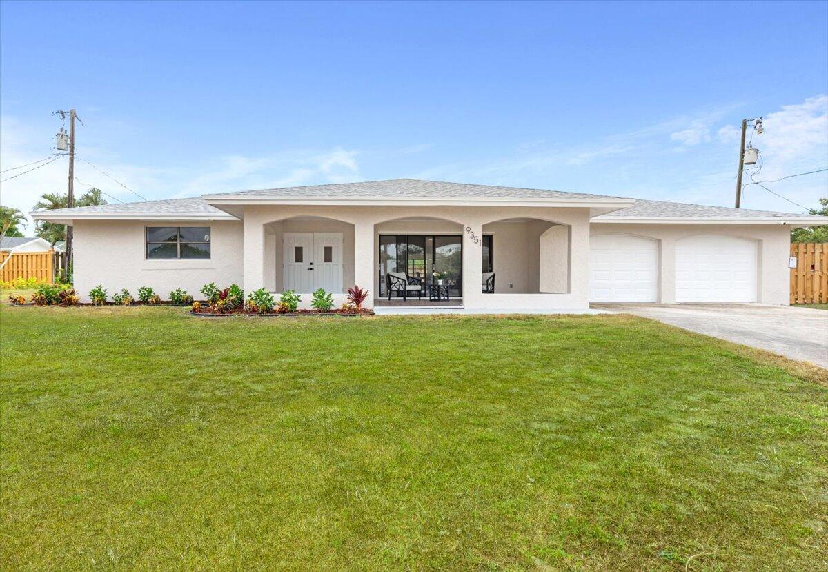 a front view of house with yard and green space