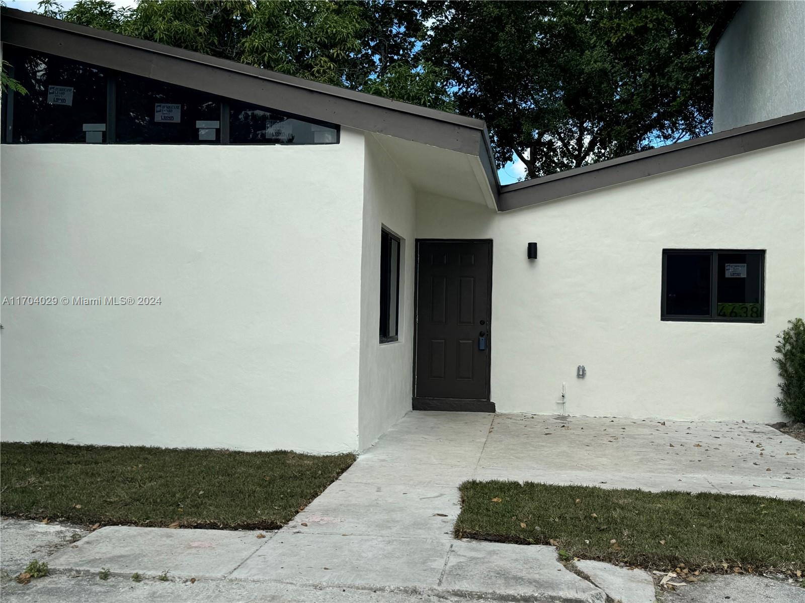 a view of small house with white walls