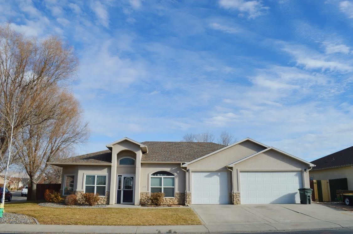 a front view of a house with a yard