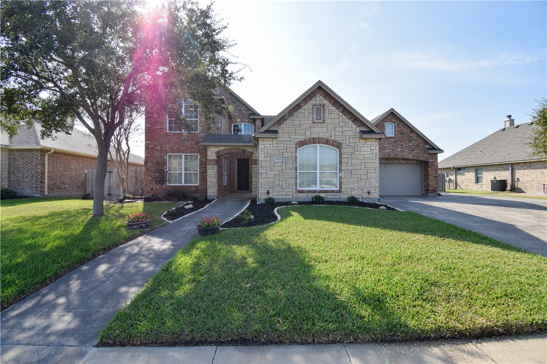 a front view of house with yard and green space