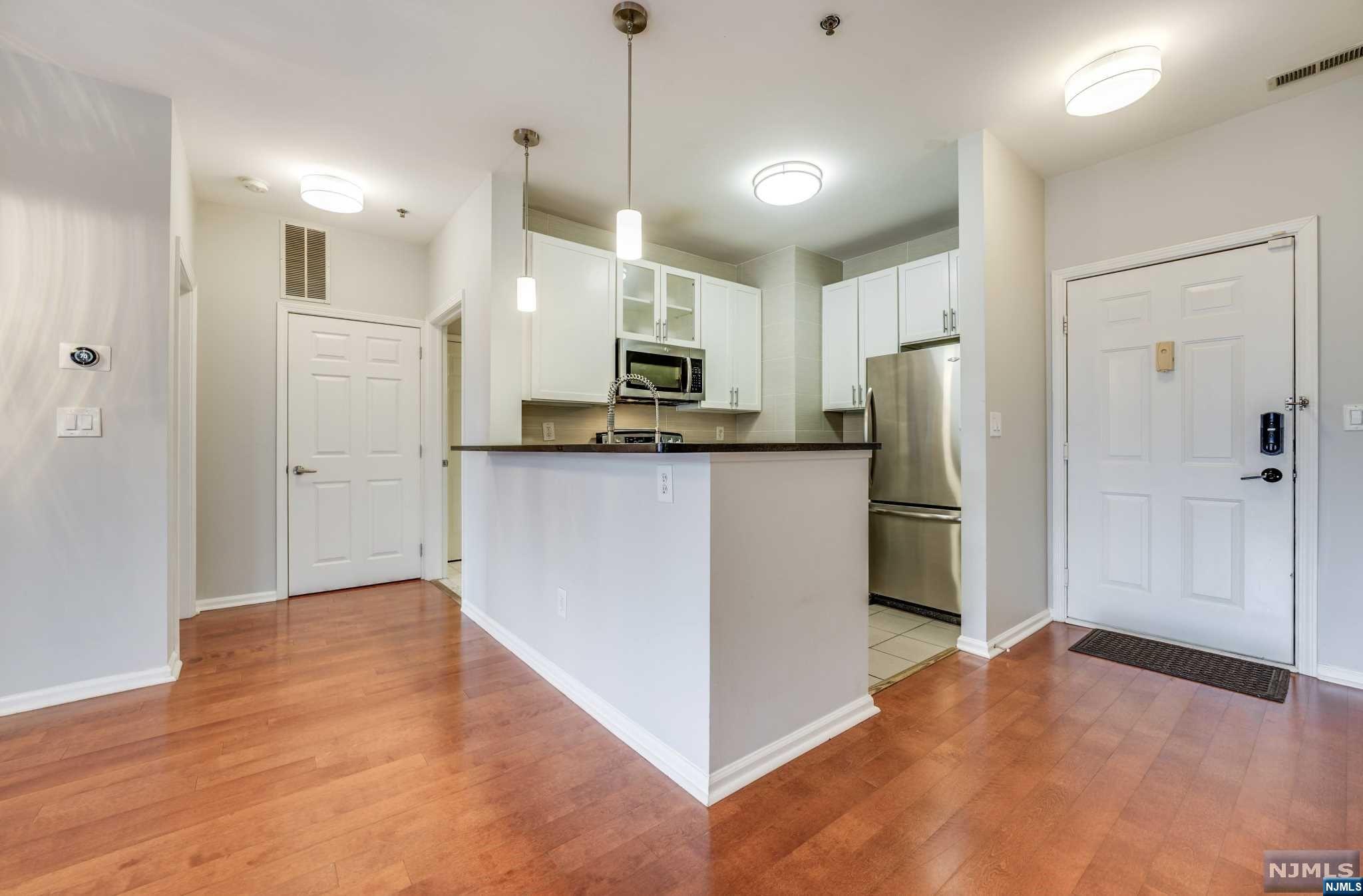 a kitchen with stainless steel appliances a refrigerator and a stove top oven