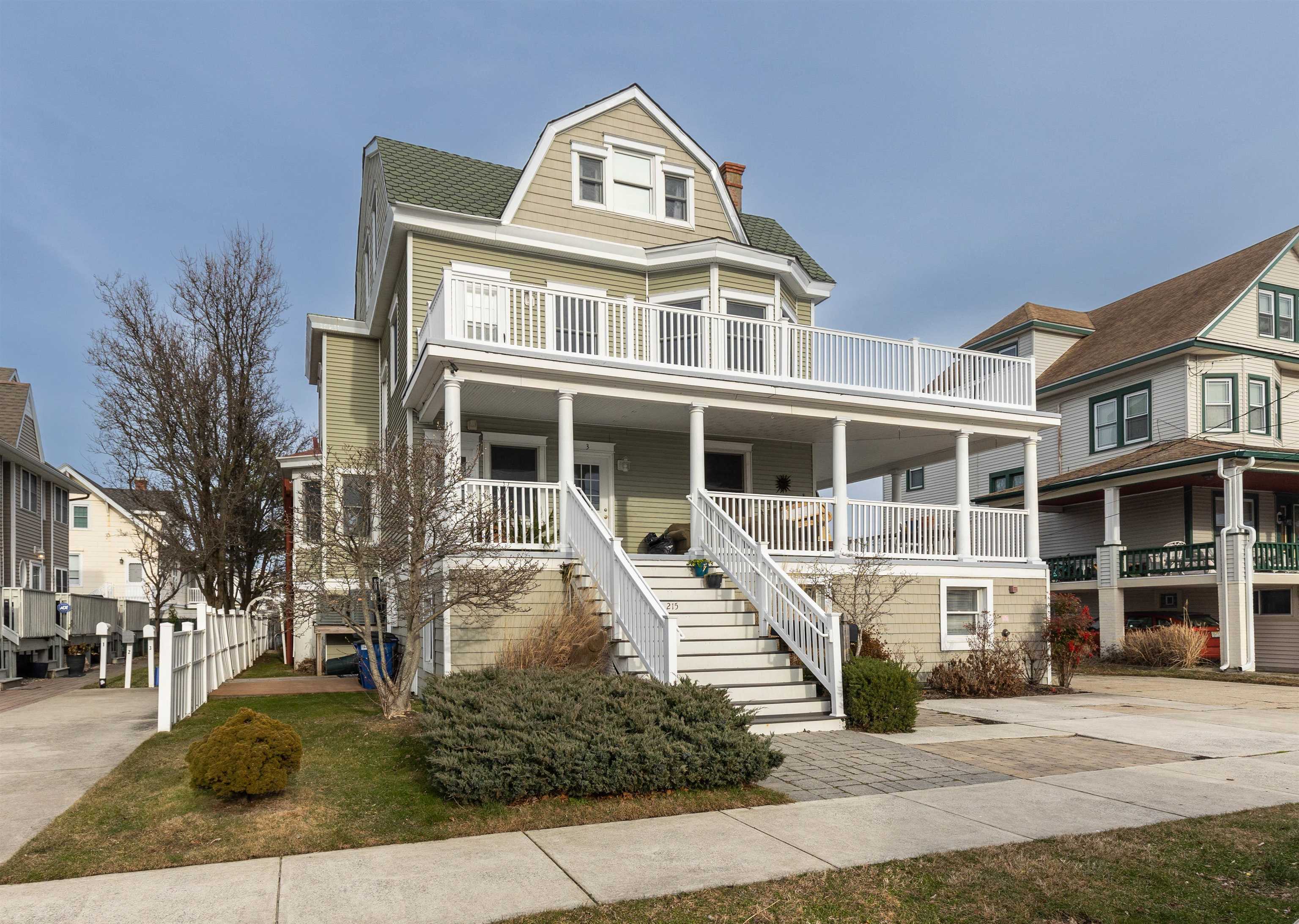 a front view of a residential apartment building with a yard