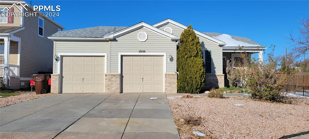 View of front of property featuring a garage