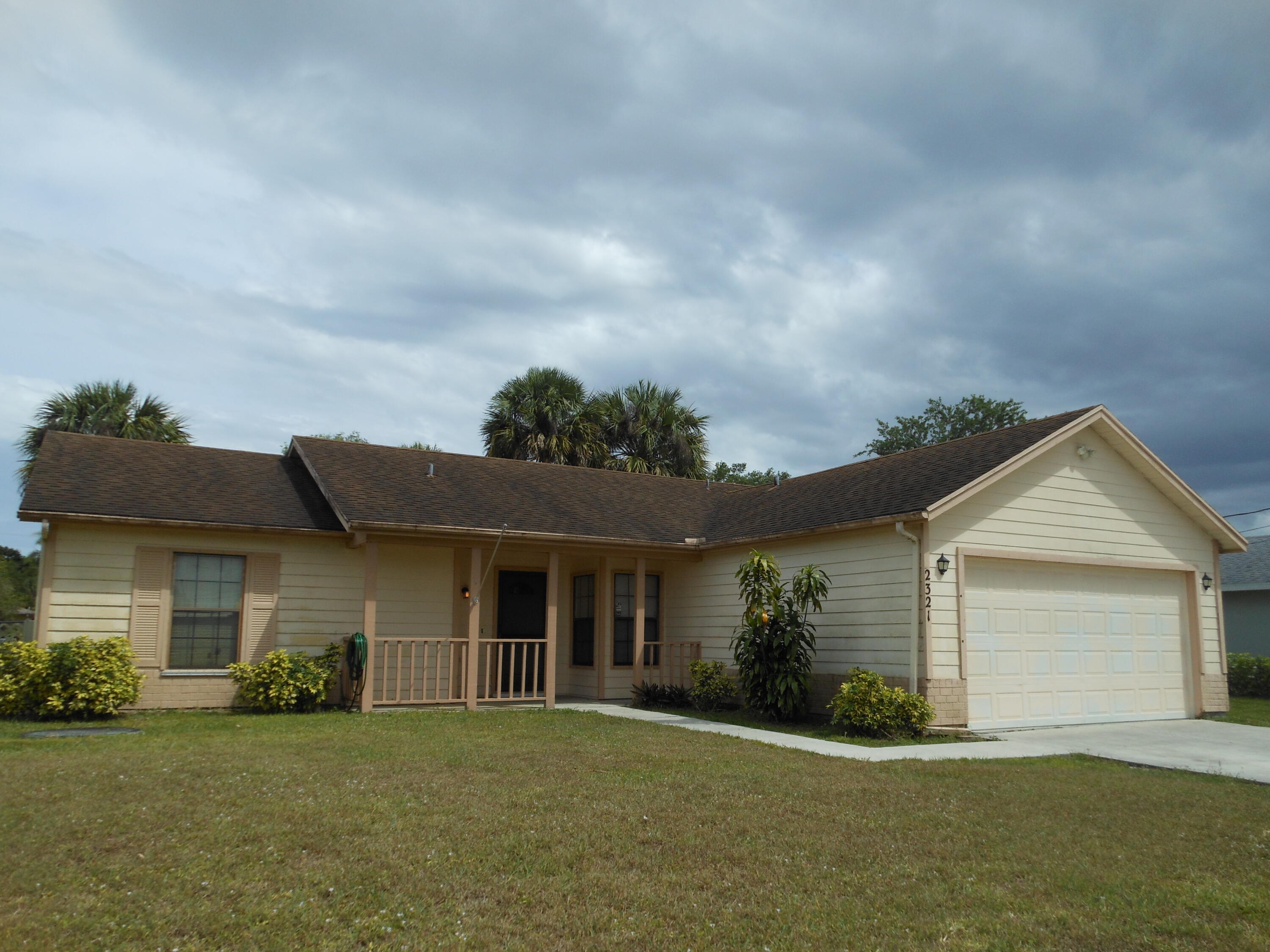 front view of a house with a garden