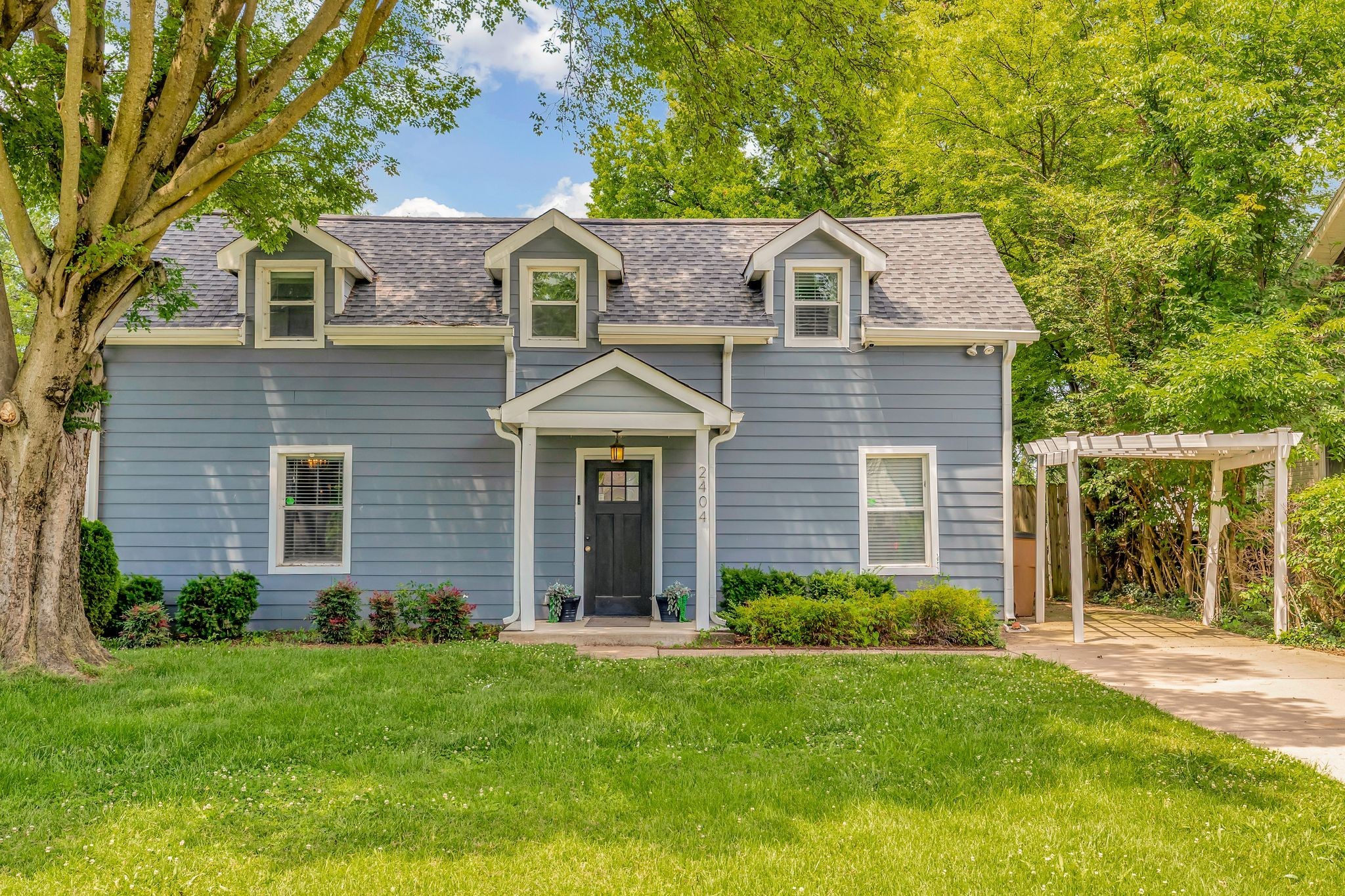 a front view of a house with a garden