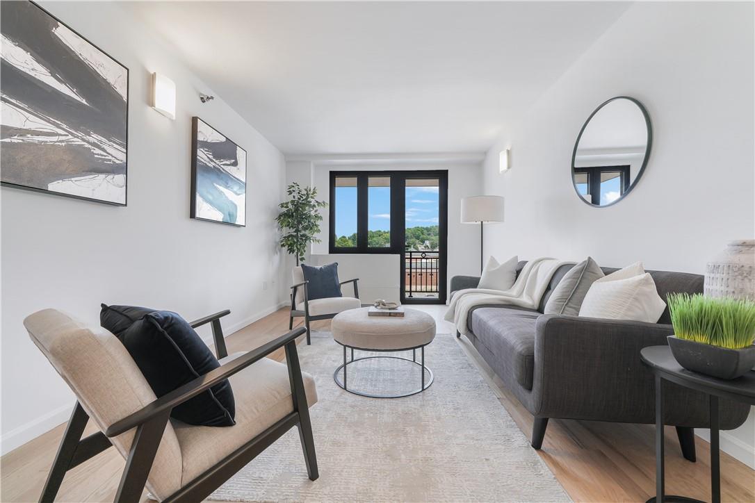 Living room with light hardwood / wood-style flooring