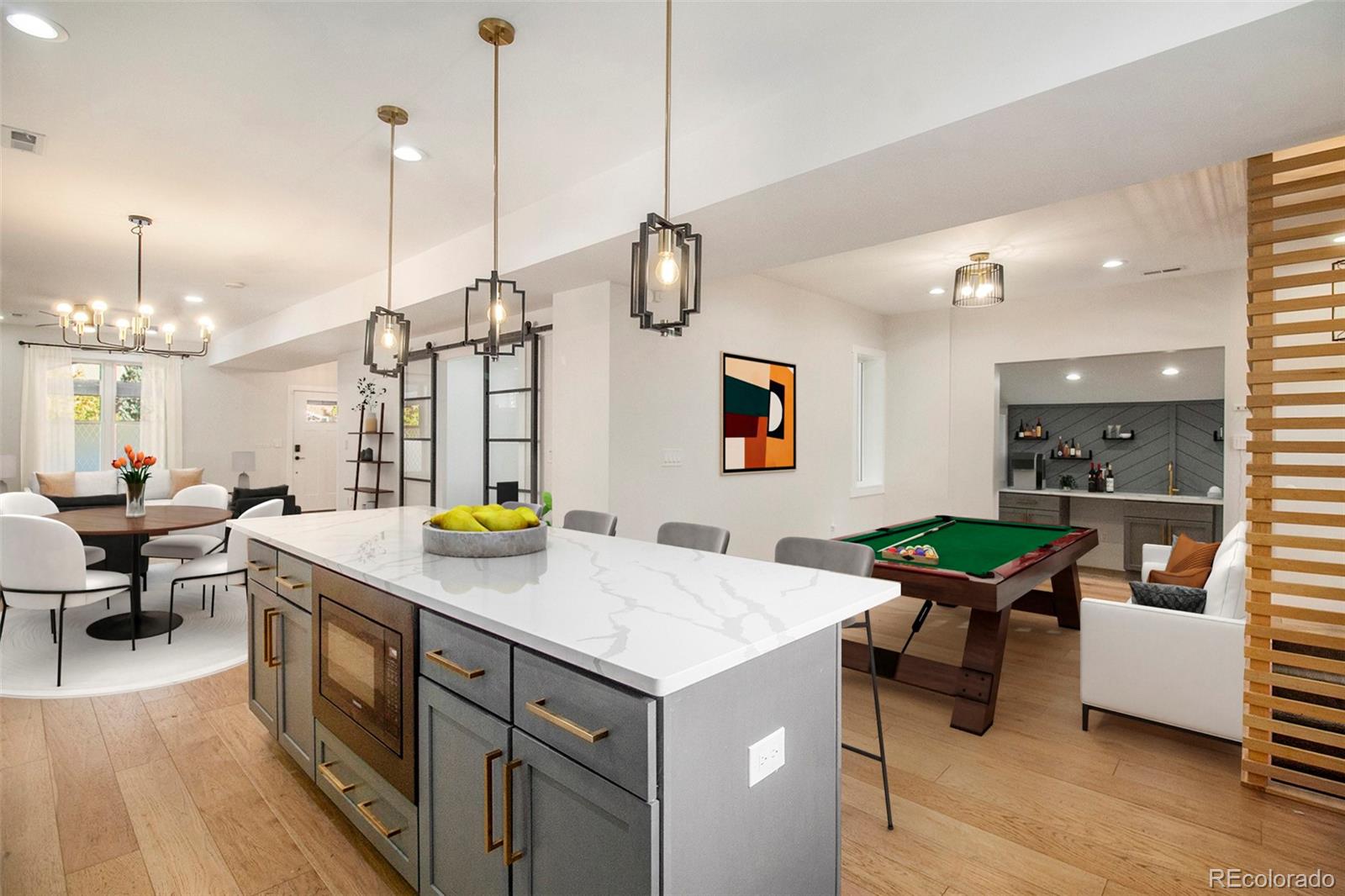 a kitchen with sink and chairs