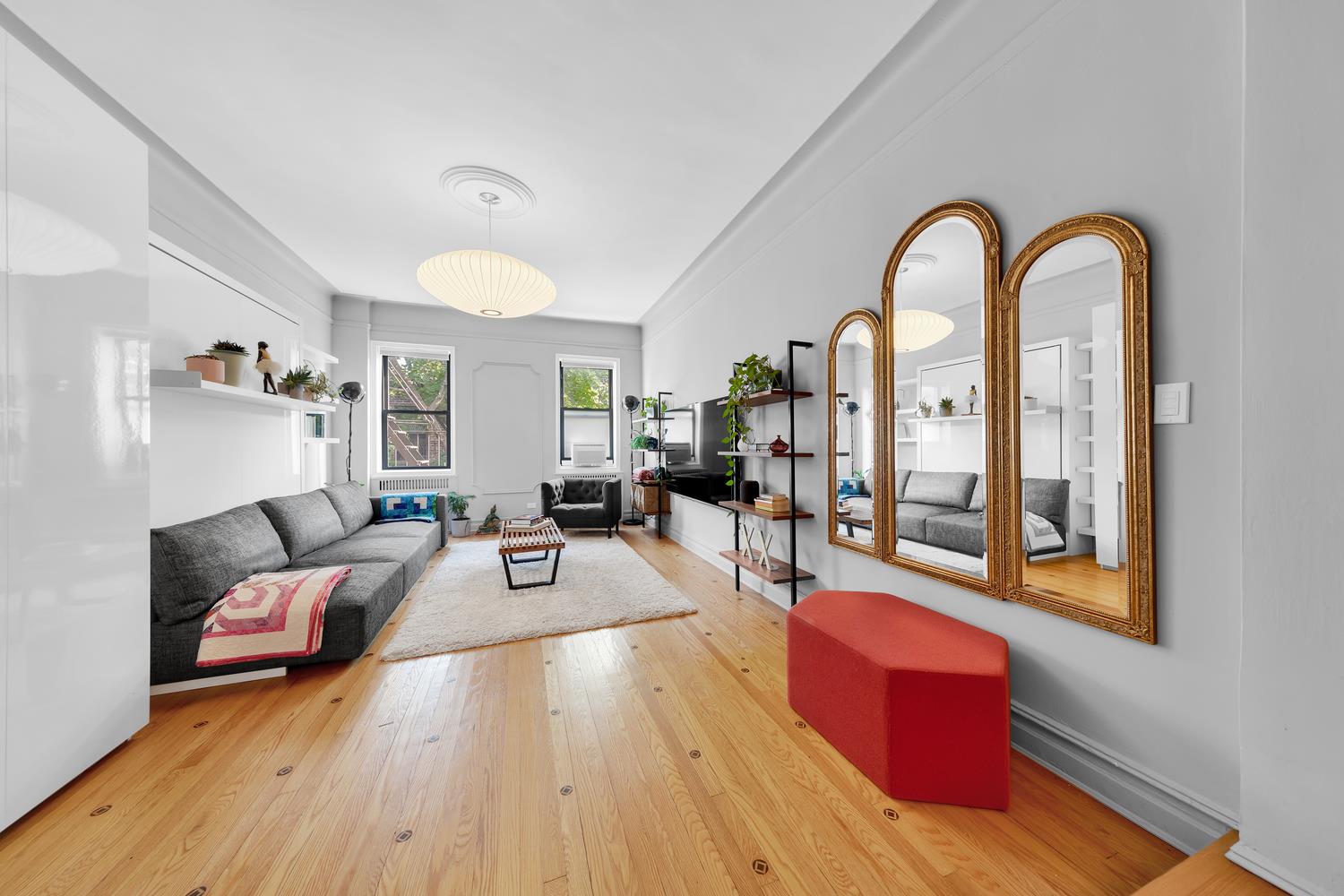 a living room with furniture fireplace and a window