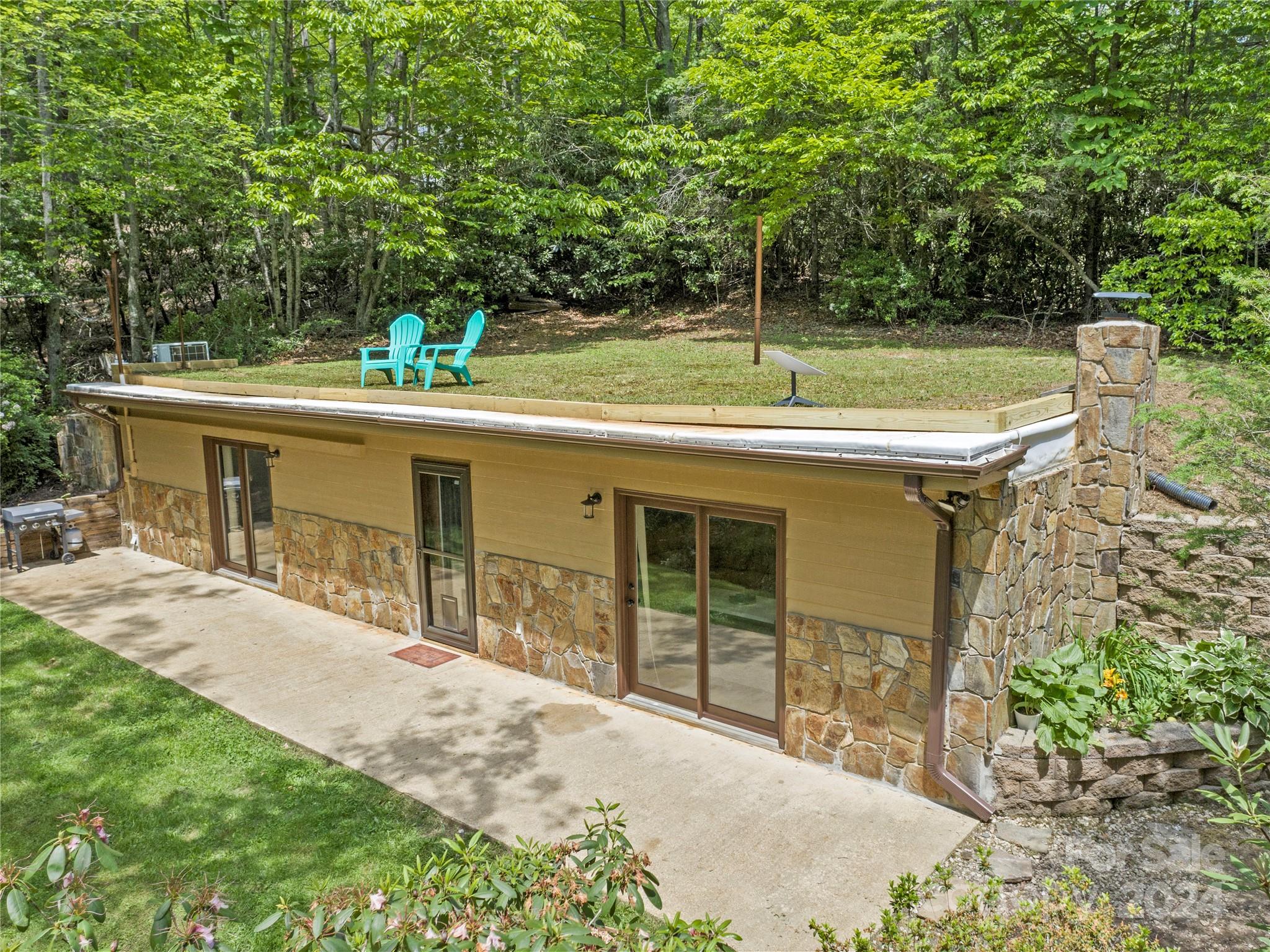 a view of a house with a backyard and a patio