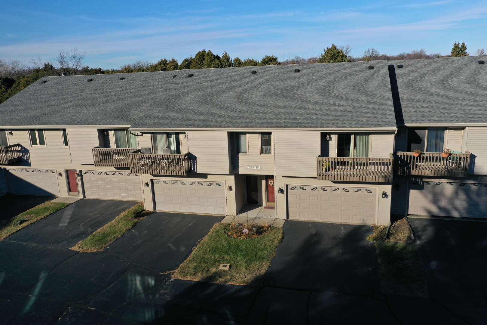 a aerial view of multiple houses with a big yard