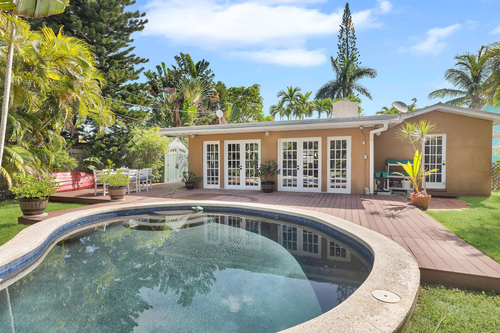 a swimming pool with outdoor seating and yard