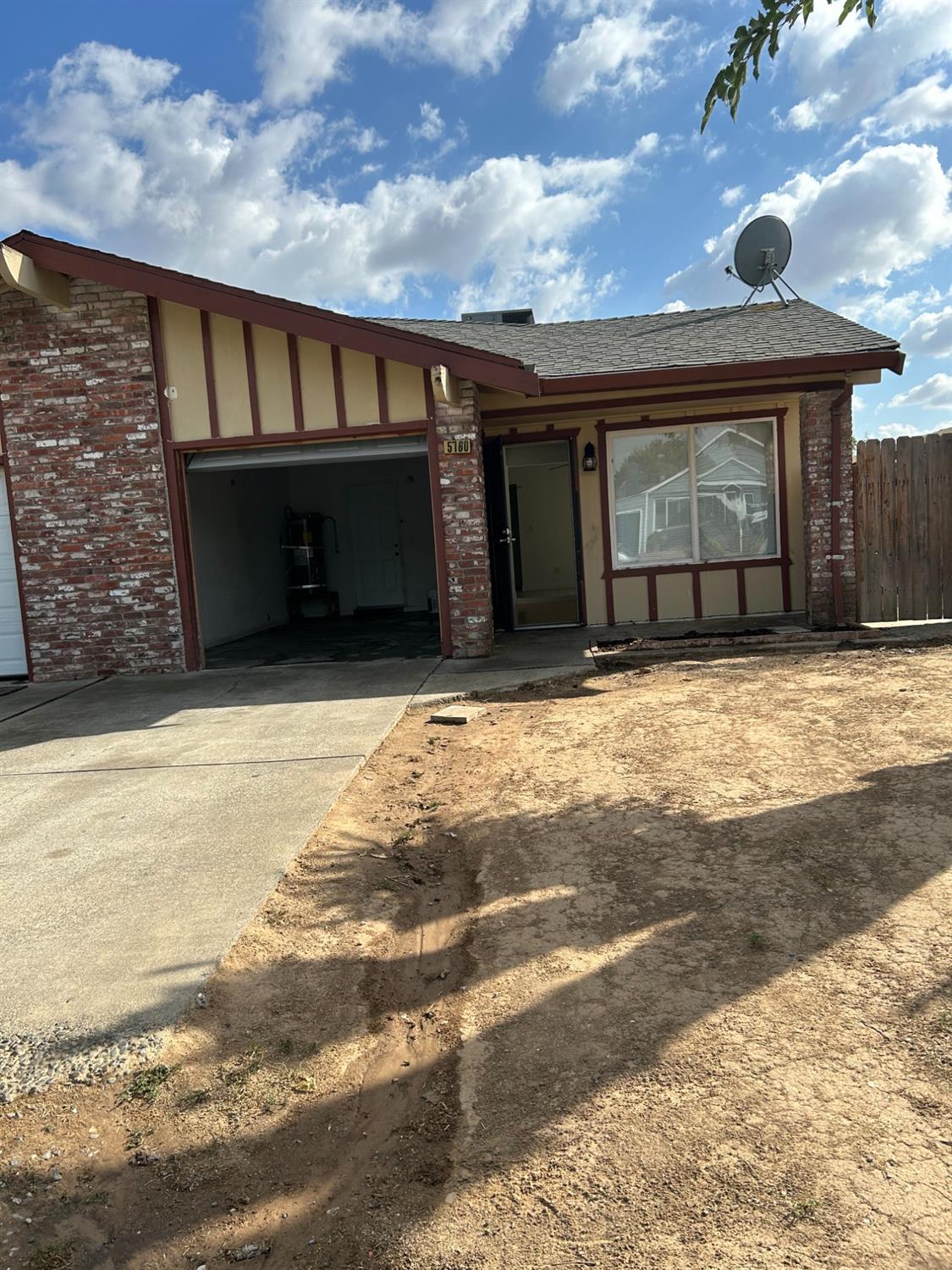 a view of a house with wooden fence