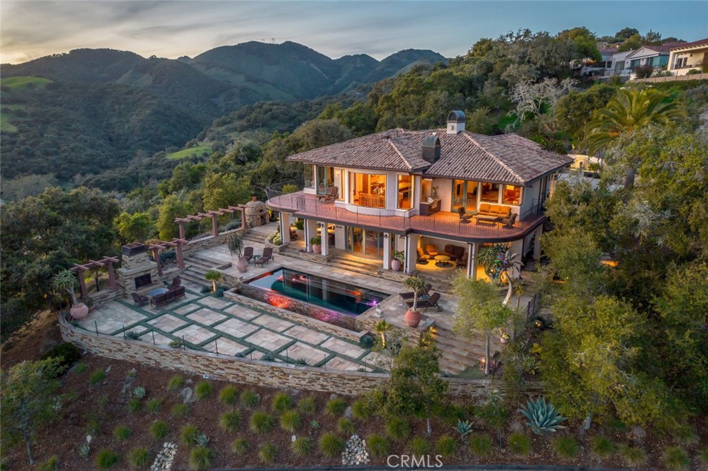 an aerial view of a house with a yard