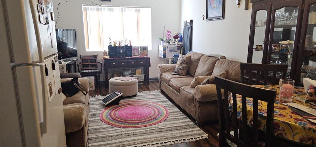 a living room with furniture and a floor to ceiling window