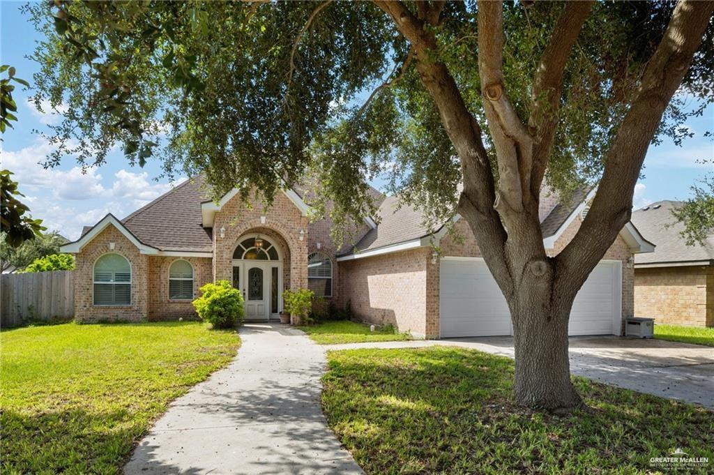 View of front of home with a front yard and a garage