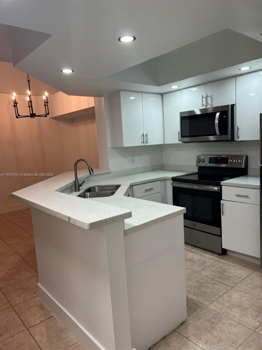 a kitchen with stainless steel appliances a sink and a stove