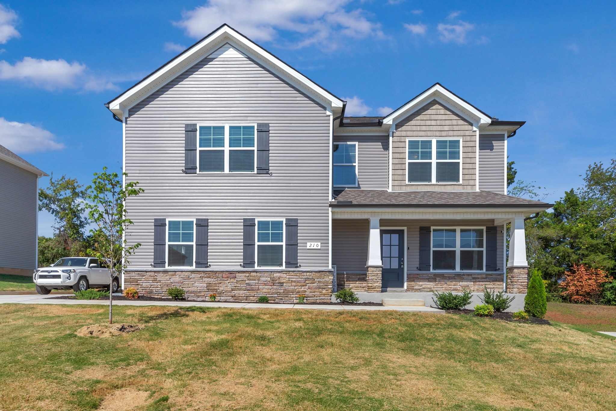 a front view of a house with a yard