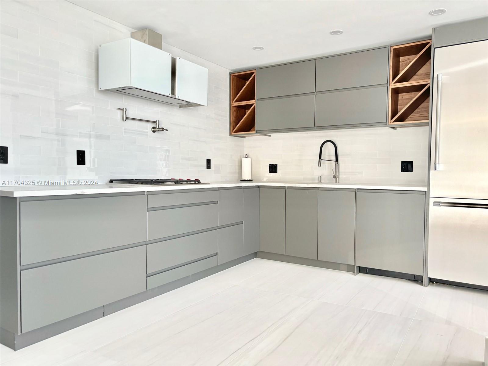 a kitchen with stainless steel appliances a sink and cabinets