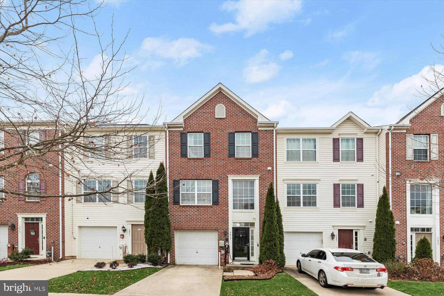 a front view of a residential apartment building with a yard