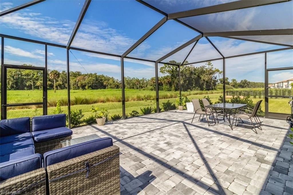 a view of a patio with a table chairs and a umbrella