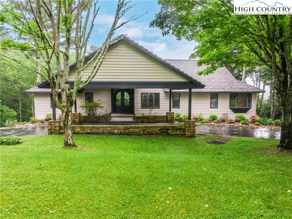 a front view of house with yard and outdoor seating