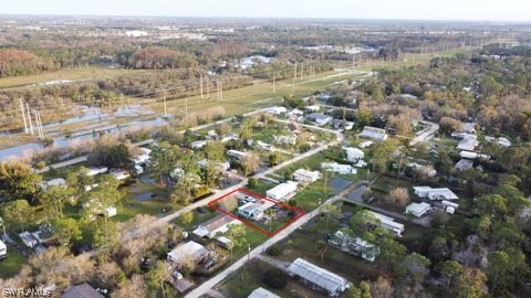 an aerial view of residential houses with outdoor space and trees