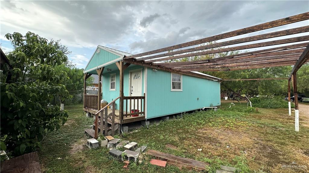 a backyard of a house with table and chairs