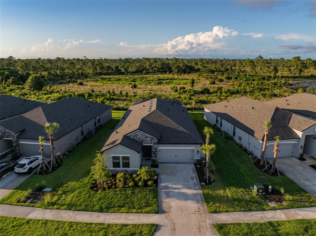 an aerial view of a house with a yard