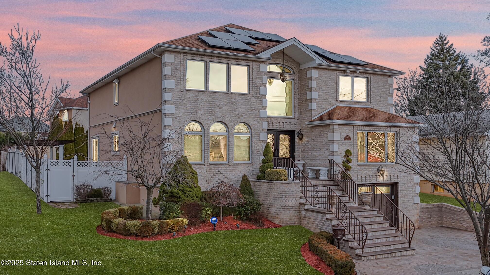 a front view of a house with a garden