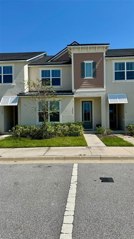 a front view of a house with a yard