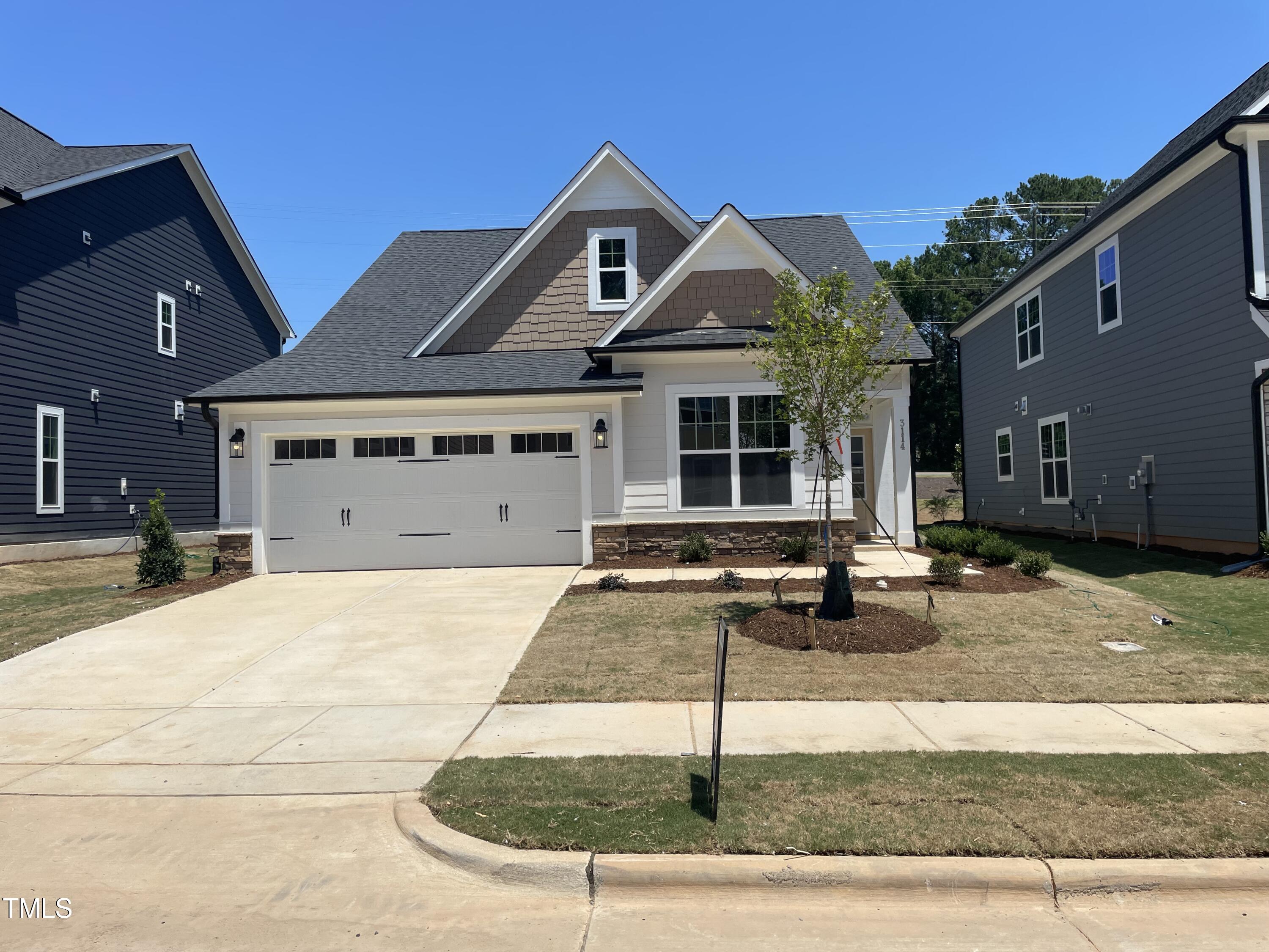 a front view of a house with parking area