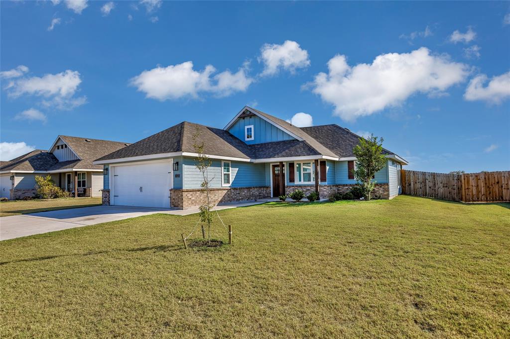 a front view of house with yard and entertaining space