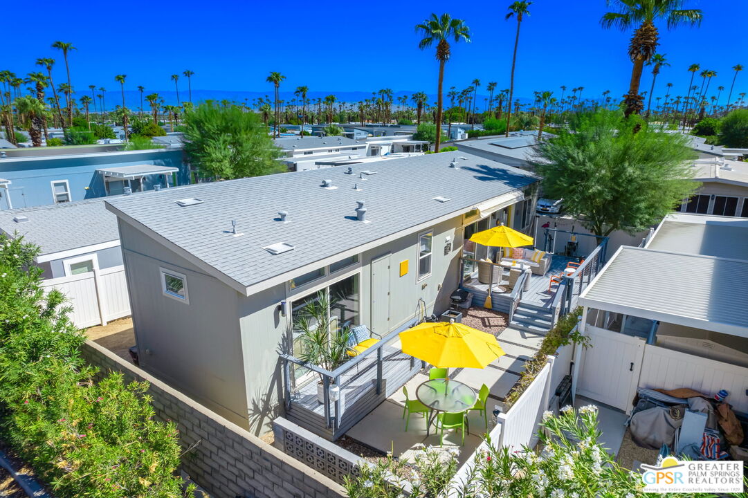 an aerial view of a house with swimming pool outdoor seating