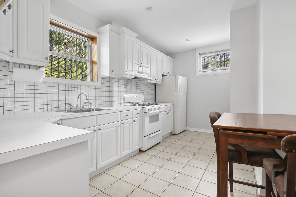 a kitchen with a sink cabinets and window