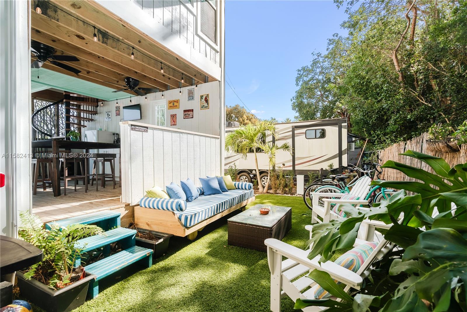 a view of a patio with couches table and chairs with potted plants