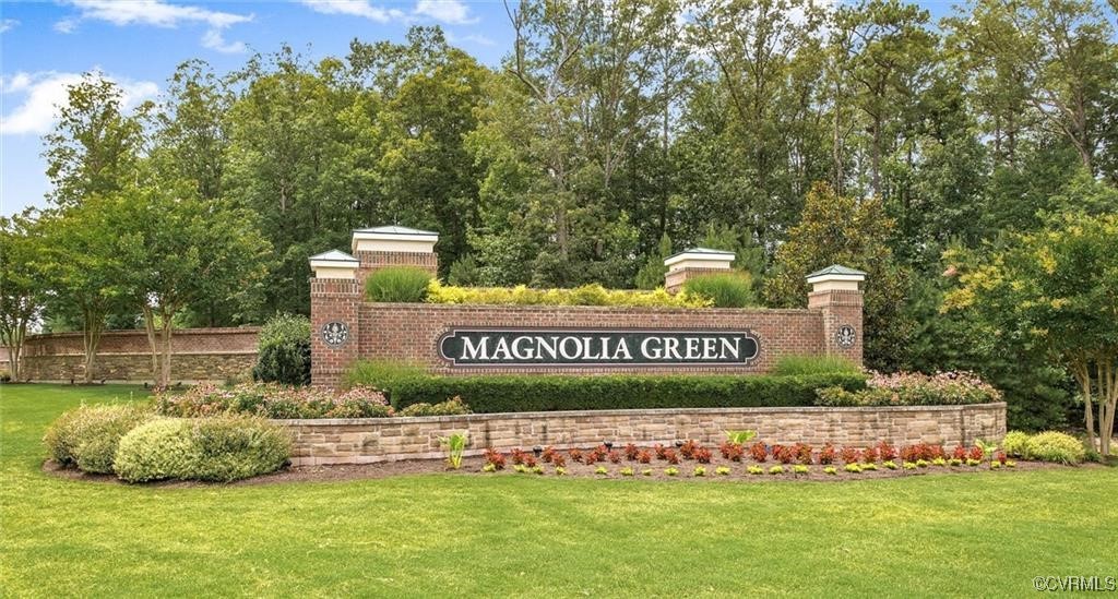 a view of outdoor space with sign board and yard