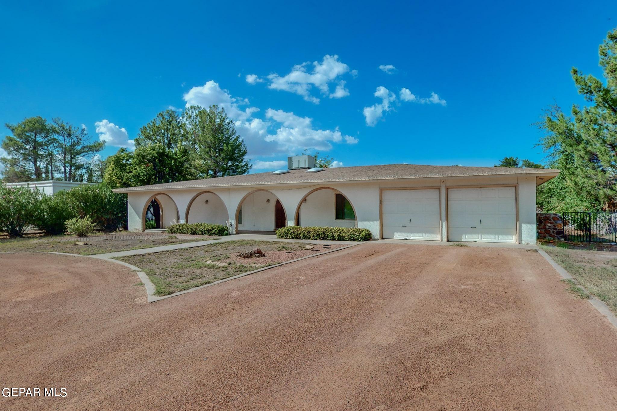 a front view of a house with yard and garage