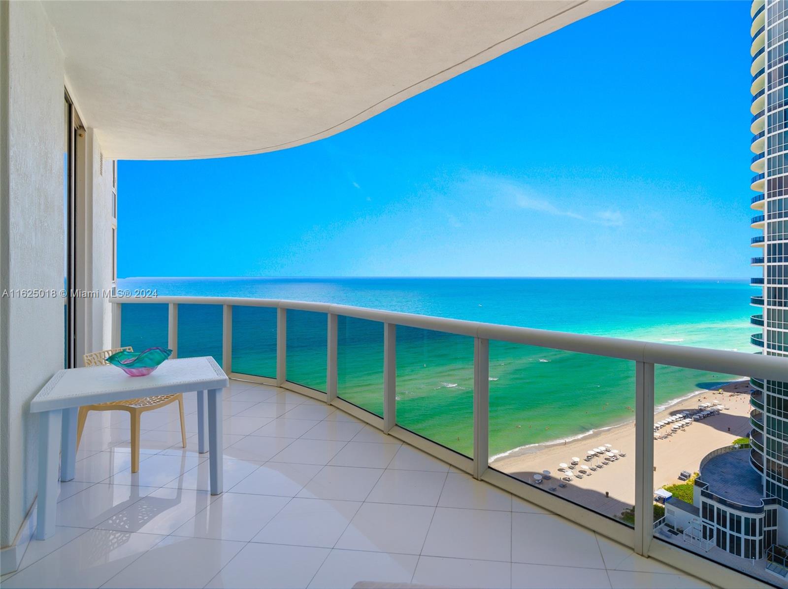 a balcony with table and chairs