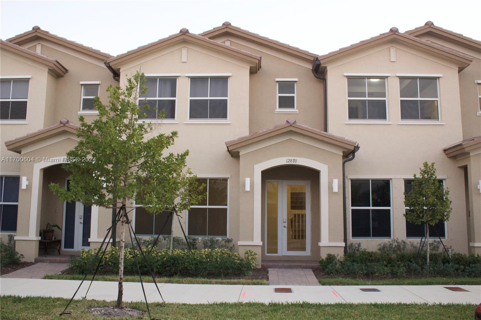 a front view of a house with a yard