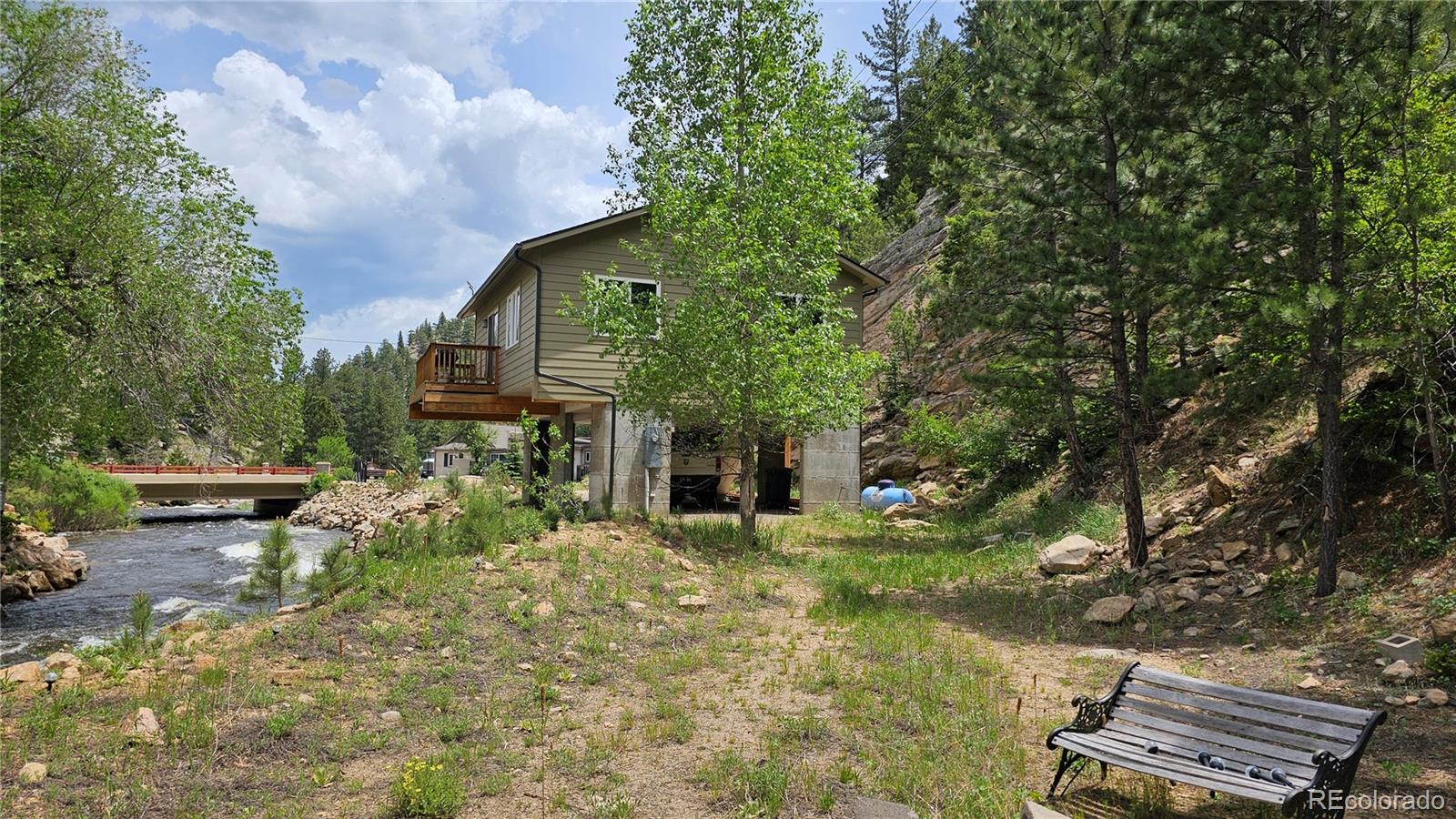 a view of a house with a yard and sitting area