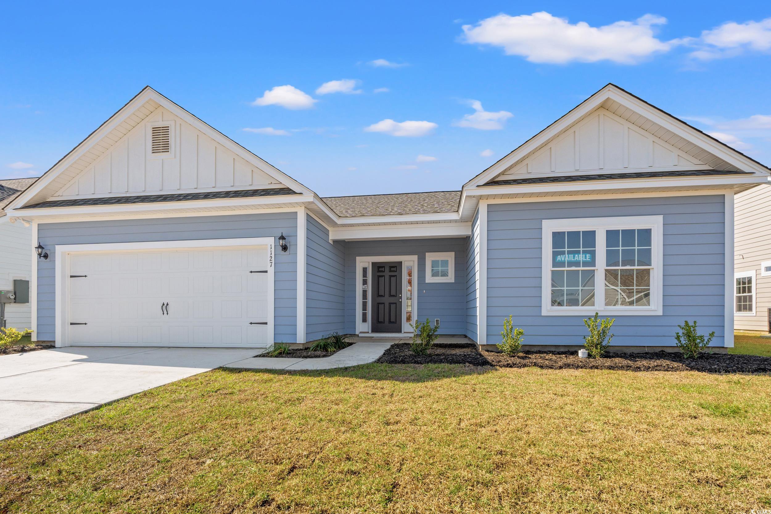 View of front of property featuring a garage and a