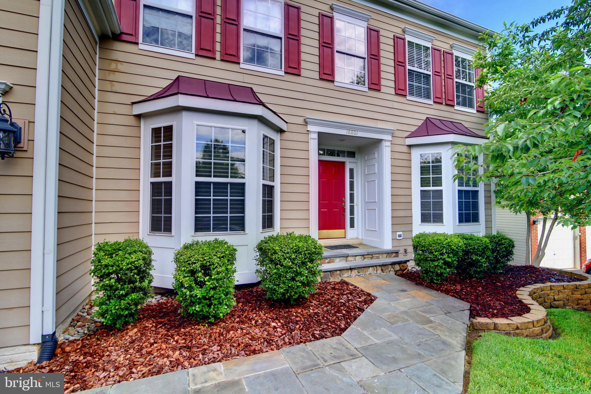 a view of a house with brick walls and a yard