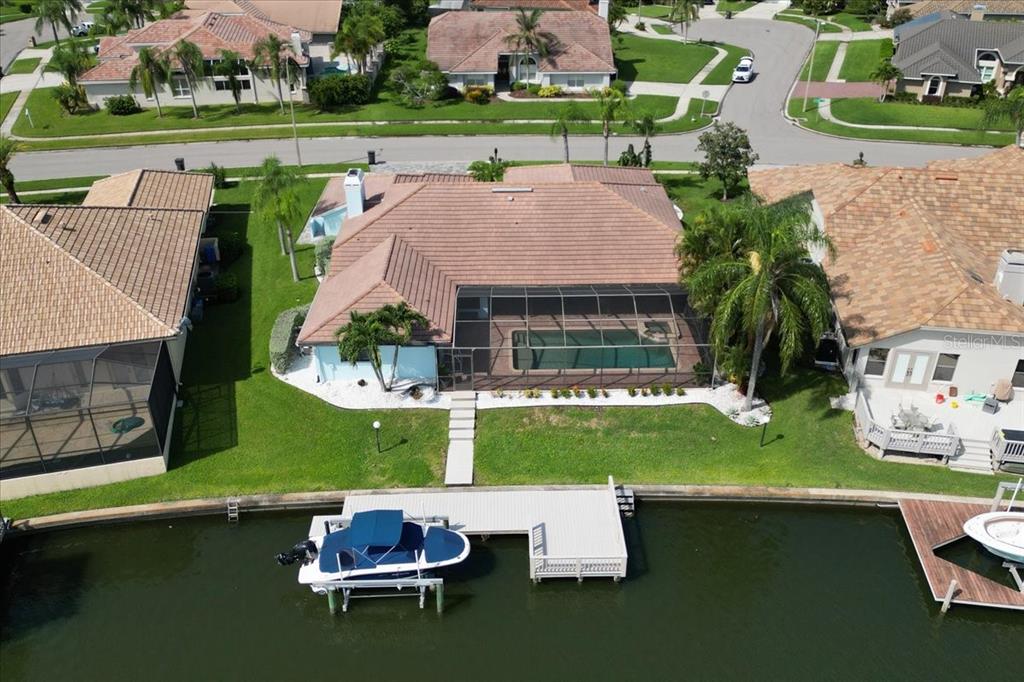 an aerial view of a house with swimming pool garden and patio