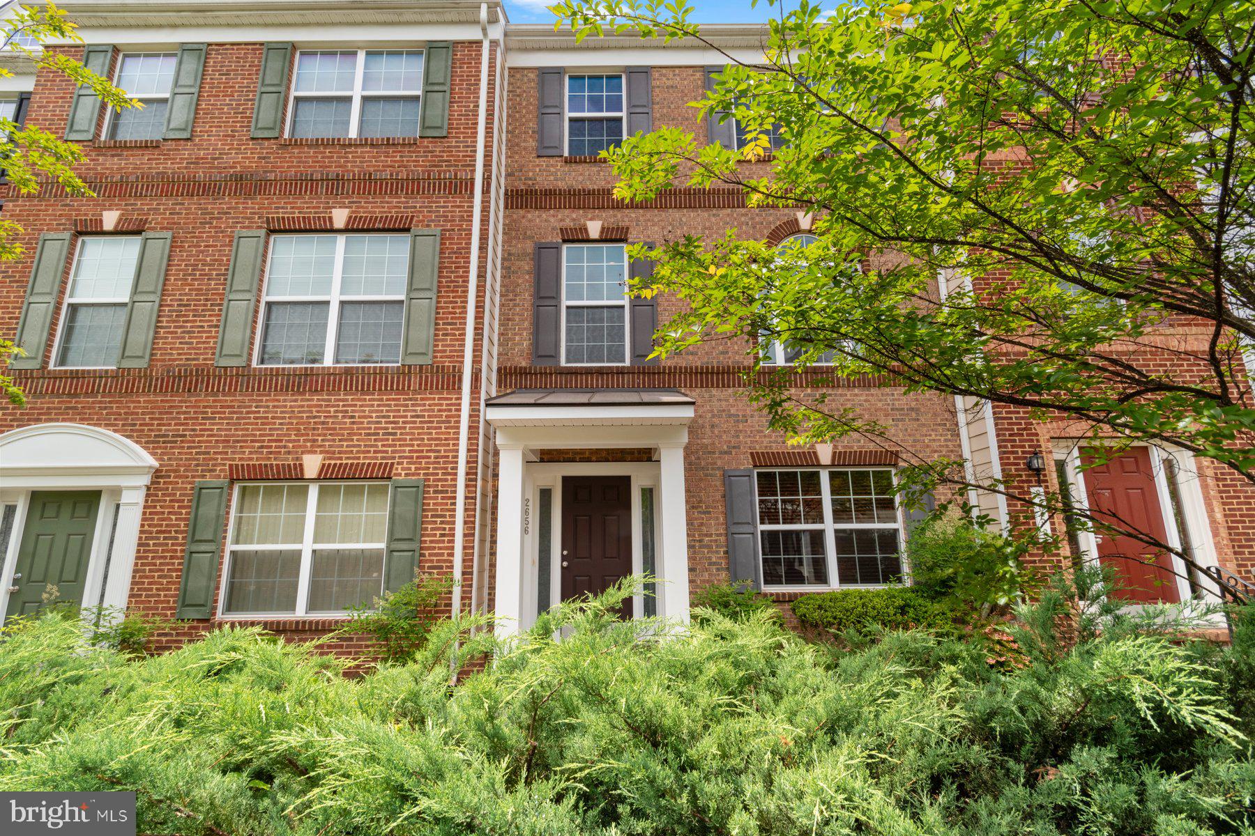 front view of a brick house with a large window