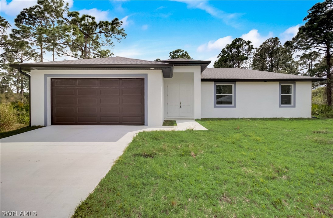 a front view of a house with a yard and garage