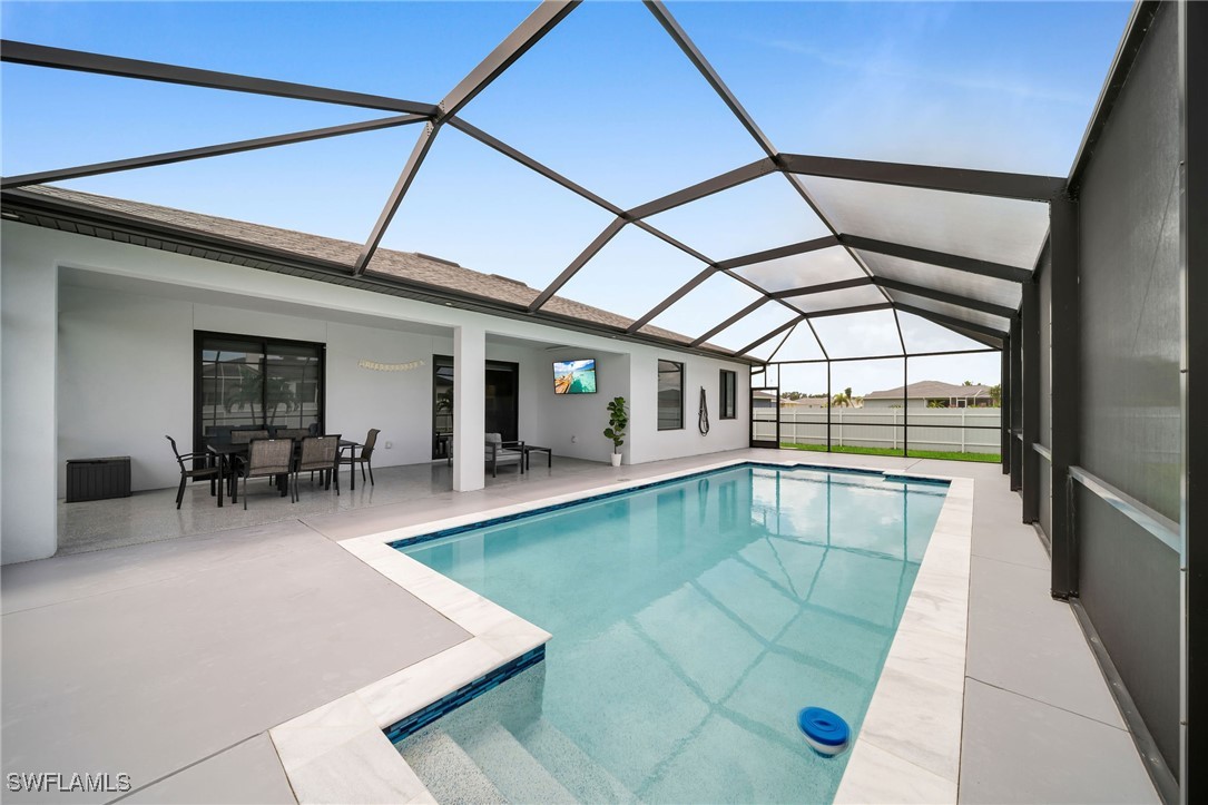 a view of swimming pool with outdoor seating