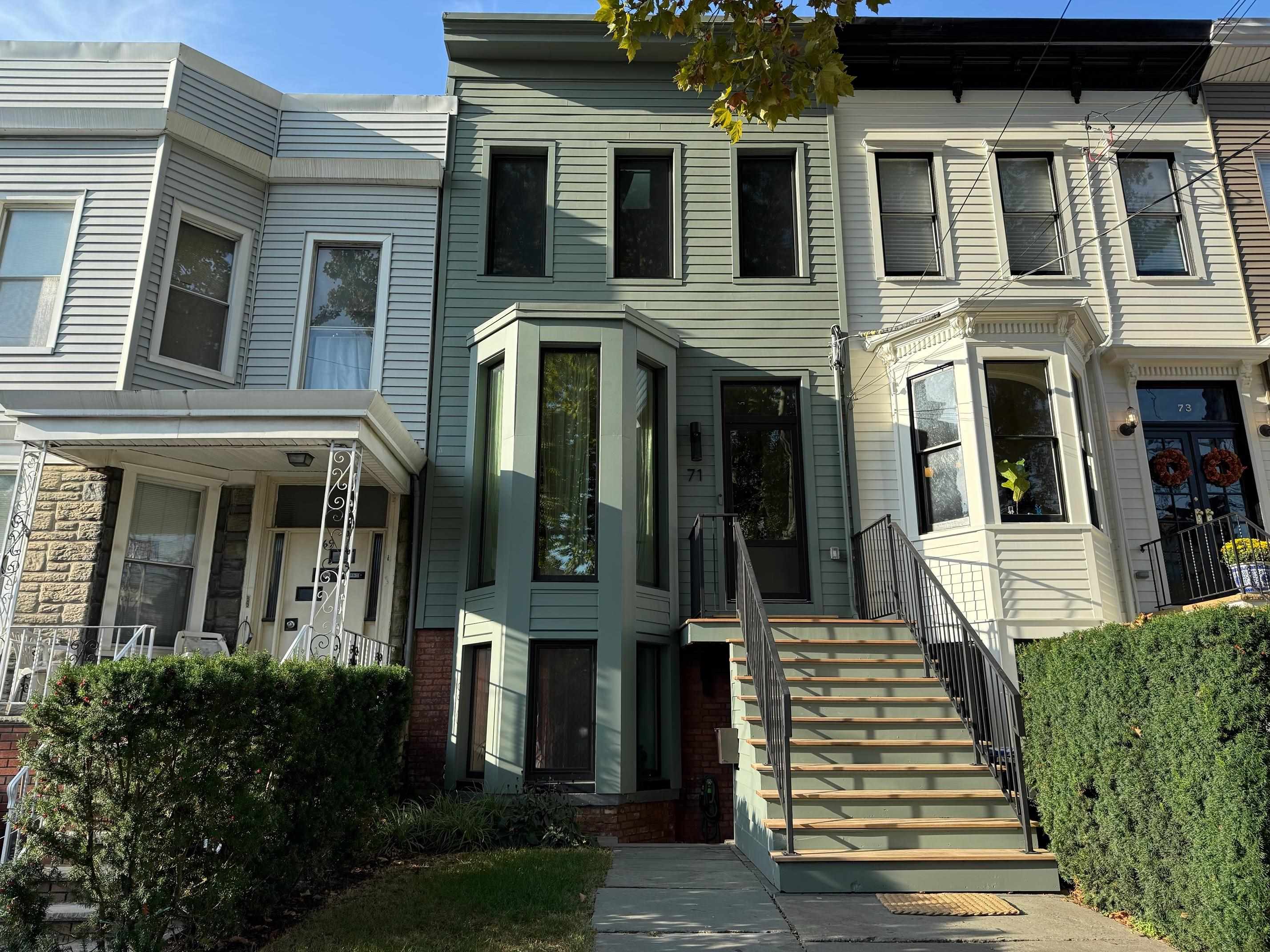 a front view of a residential apartment building with a yard