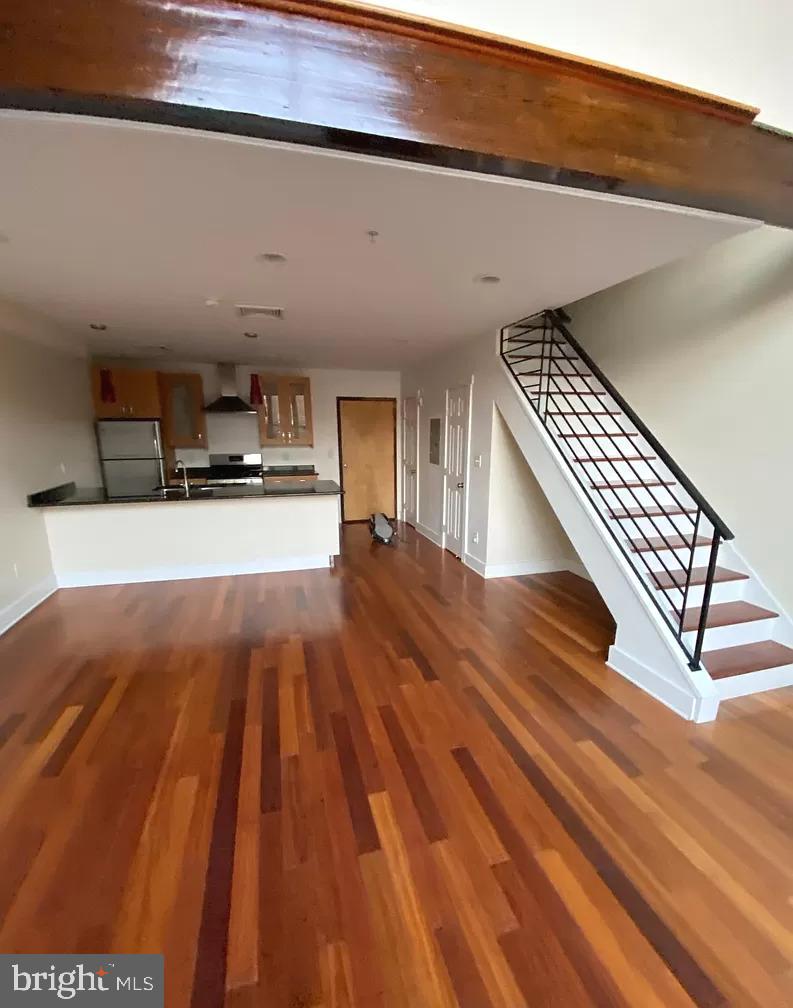 a view of kitchen with cabinets and wooden floor