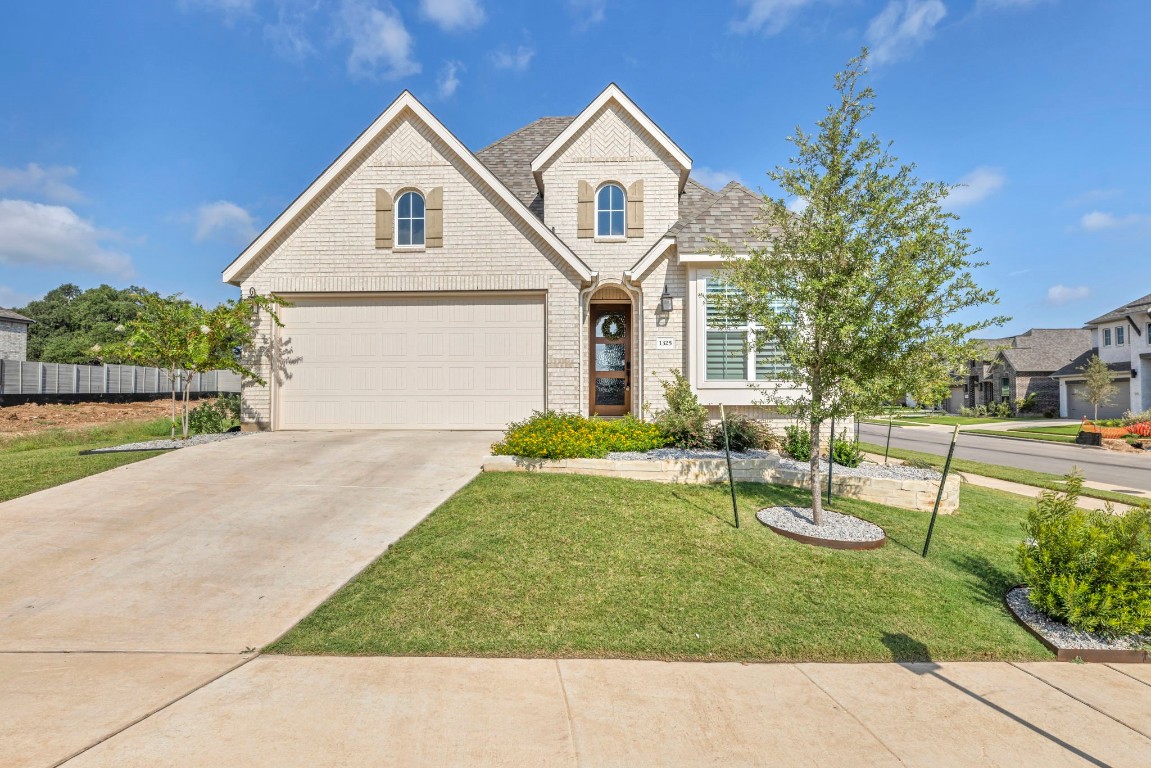 a front view of a house with garden